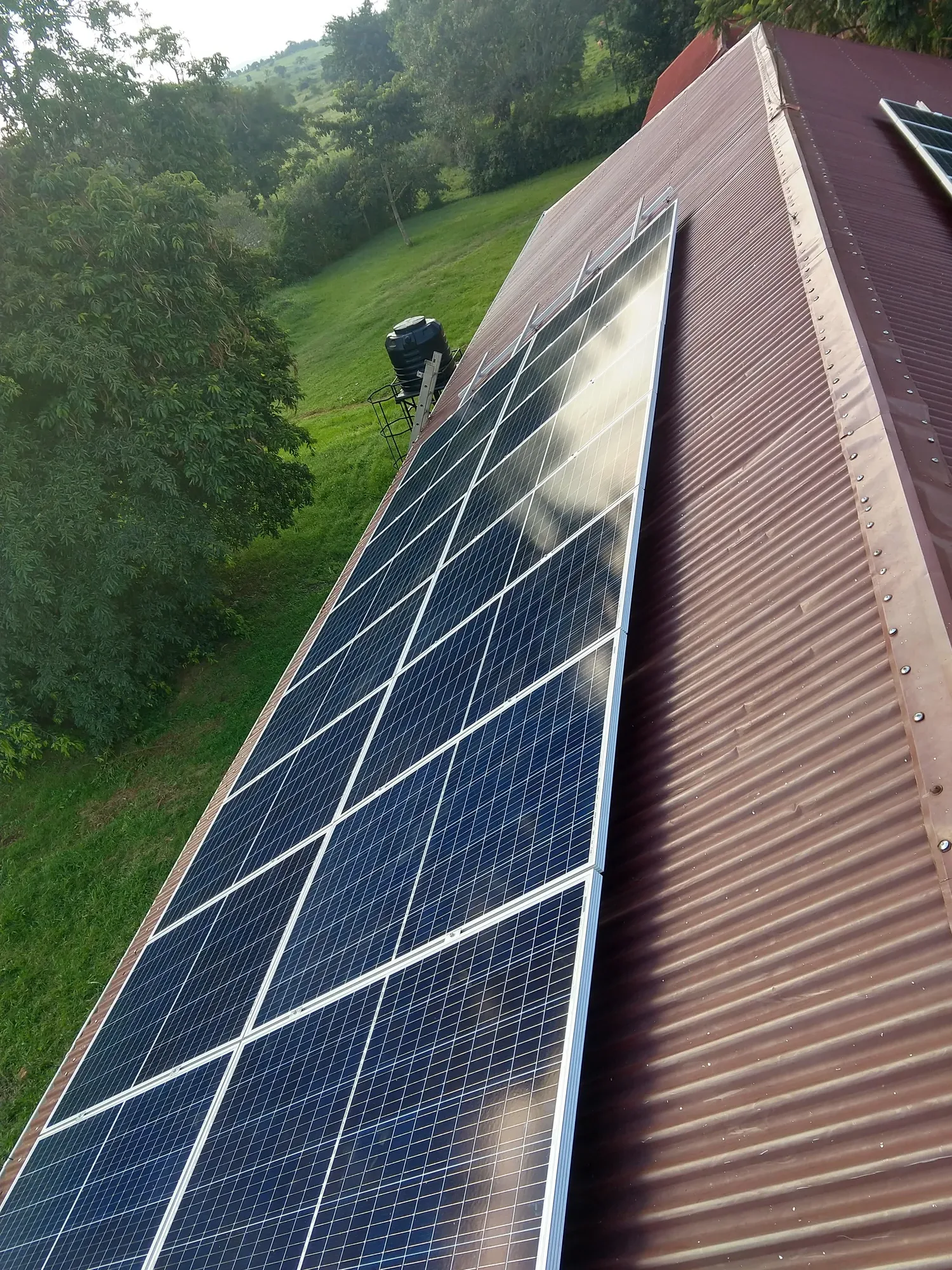 Equator Solar service team at a hospital solar installation in Uganda